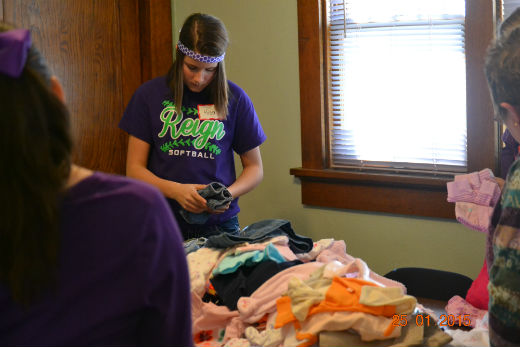 Sixth graders sort clothes Sixth Graders sorting clothes