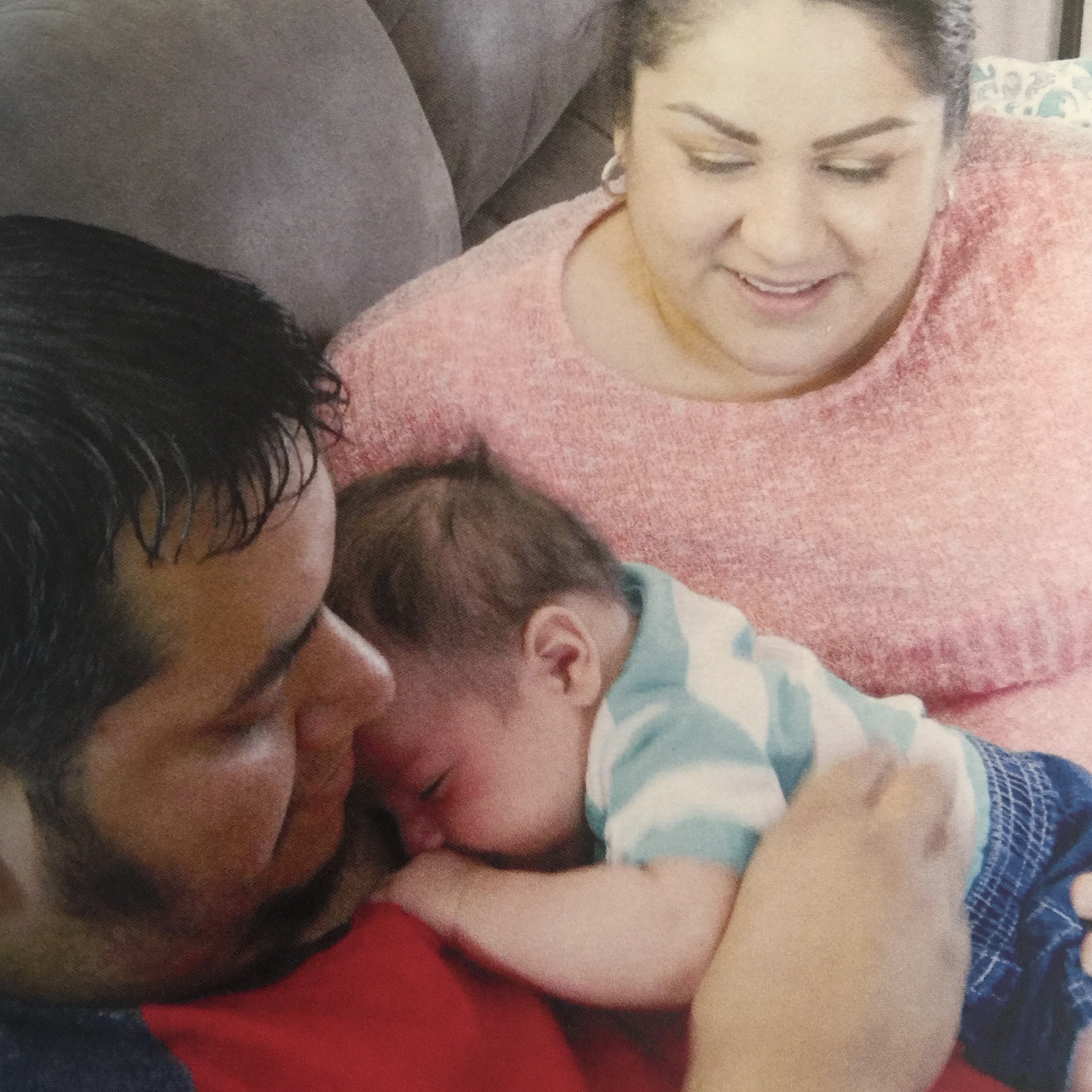Roberto and Brianna Morales hold their adopted son.